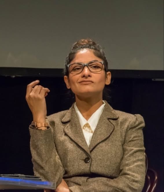 Close-up of a woman in glasses from An Enemy of the People.