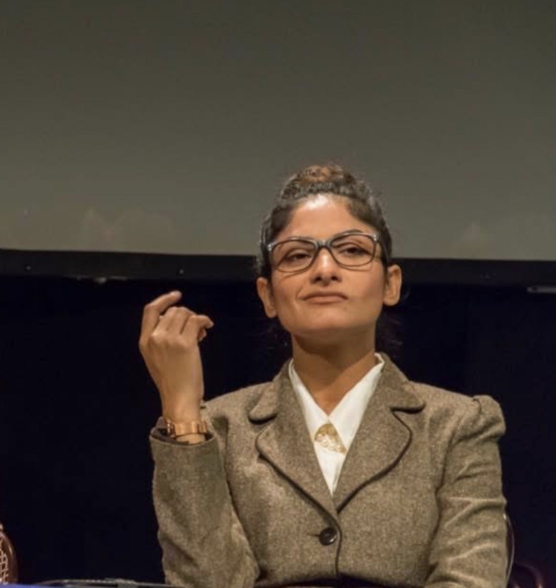 Close-up of a civic authority figure in An Enemy of the People, seated with a controlled expression.